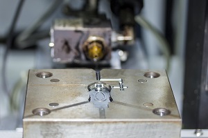 Closeup of an open plastic injection mold for inspection. 