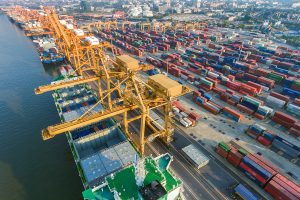 Shipping containers waiting for loading into cargo ships for overseas shipping from shipyard.