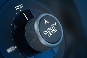 Dial set to high with the words "quality level" on them, representing quality management systems.