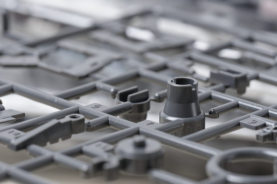 A closeup of small plastic parts meant to signify plastic injection molding shrinkage.