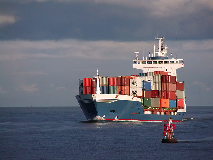 A container ship transporting cargo meant to signify offshore mold makers.