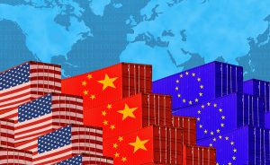 Cargo containers with American, China, and EU falgs on them on a backdrop of a world map.