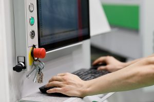 Operater on CAD machine working on prototyping parts.
